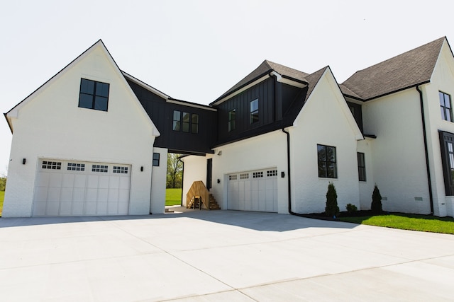 modern inspired farmhouse with a garage