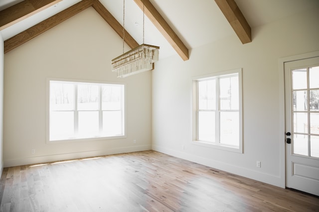 unfurnished living room featuring plenty of natural light and light hardwood / wood-style flooring