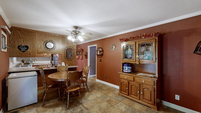 dining area featuring ceiling fan, ornamental molding, and sink