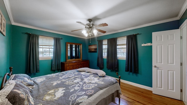 bedroom featuring hardwood / wood-style flooring, ceiling fan, and ornamental molding