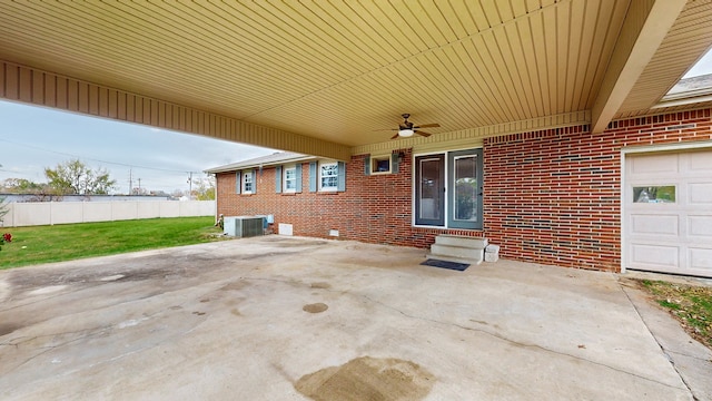 view of patio featuring central AC, ceiling fan, and a garage