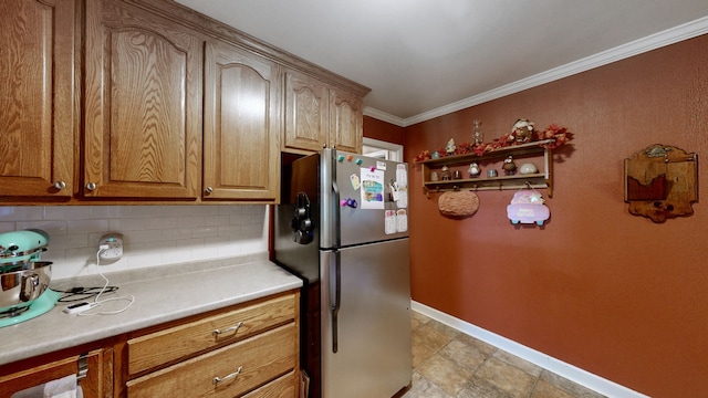 kitchen with decorative backsplash, ornamental molding, and stainless steel refrigerator