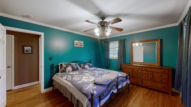 bedroom featuring hardwood / wood-style floors, ceiling fan, and ornamental molding