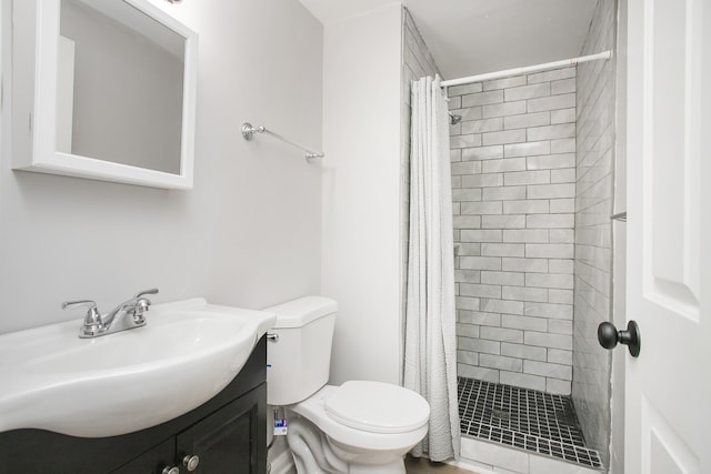 bathroom with curtained shower, vanity, and toilet