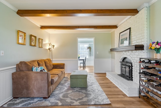 living room with hardwood / wood-style flooring and crown molding