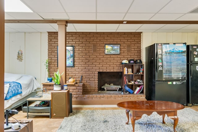 interior space featuring a paneled ceiling and a brick fireplace