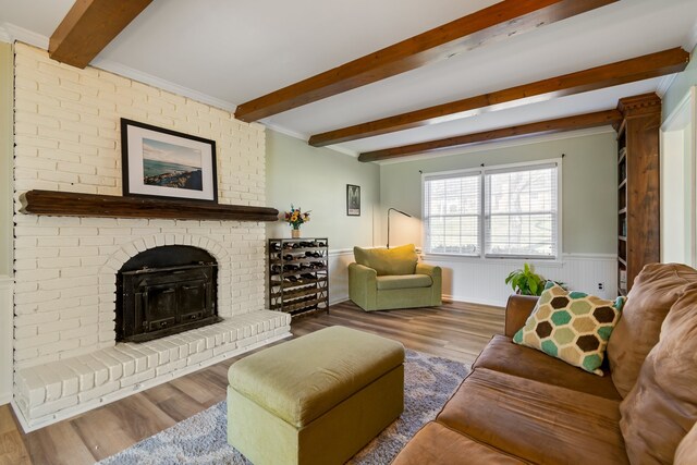 living room with beam ceiling, hardwood / wood-style flooring, and a fireplace