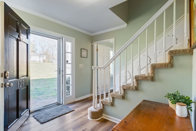 entrance foyer with crown molding and light wood-type flooring