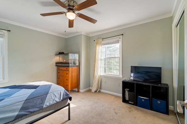 bedroom featuring crown molding, ceiling fan, a closet, and light carpet