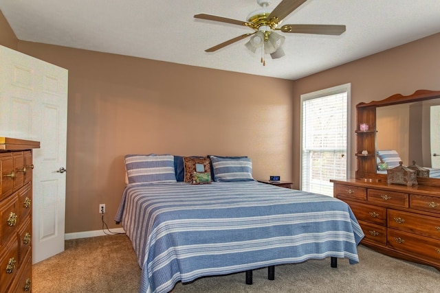 carpeted bedroom with a textured ceiling and ceiling fan