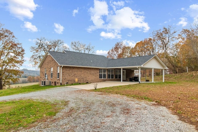 single story home with a carport and central AC