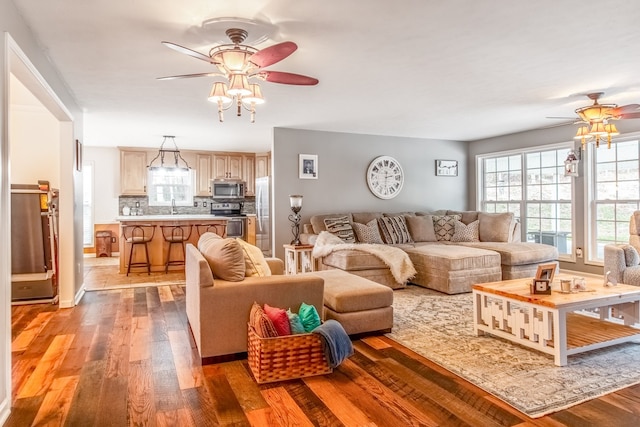 living room with light hardwood / wood-style floors and sink