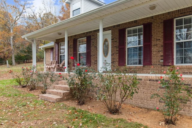 view of exterior entry with a porch