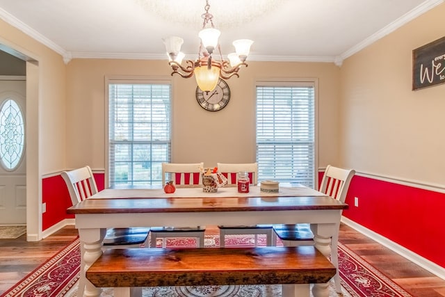 dining area with a healthy amount of sunlight, wood-type flooring, and ornamental molding