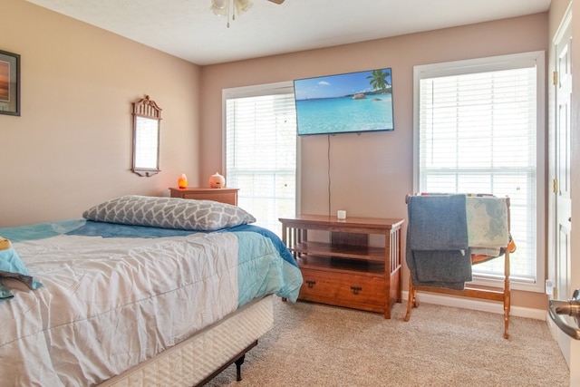 bedroom featuring ceiling fan and light carpet