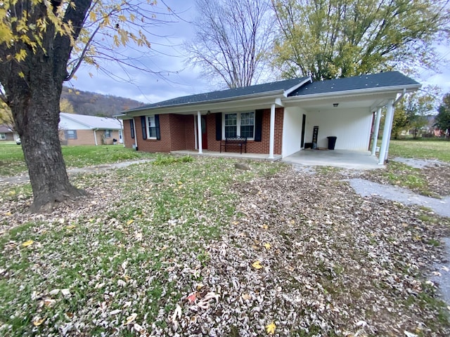 single story home featuring a carport and a front lawn