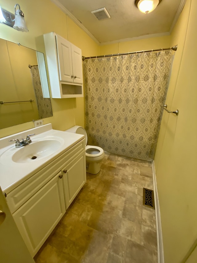 bathroom with vanity, toilet, and ornamental molding