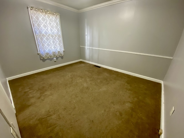 carpeted empty room featuring crown molding