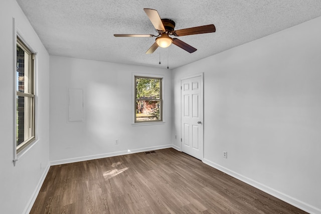 unfurnished room featuring ceiling fan, wood-type flooring, and a textured ceiling