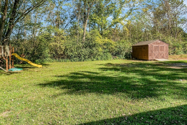 view of yard featuring a playground and a shed