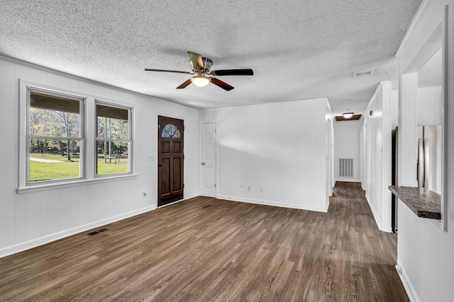 unfurnished living room featuring ceiling fan, dark hardwood / wood-style flooring, and a textured ceiling