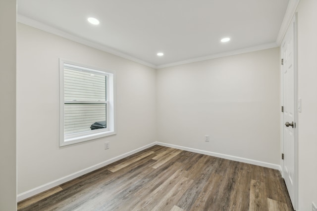 empty room with ornamental molding and dark wood-type flooring