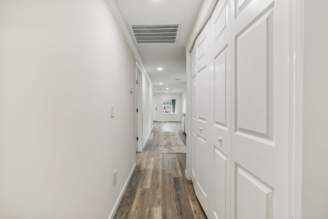 hall featuring dark hardwood / wood-style flooring and crown molding