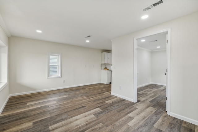 unfurnished room with dark hardwood / wood-style floors and ornamental molding