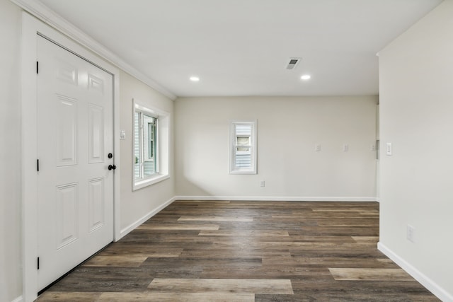 foyer entrance with dark hardwood / wood-style floors and ornamental molding