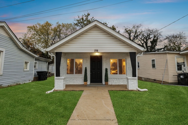 bungalow with a lawn and covered porch