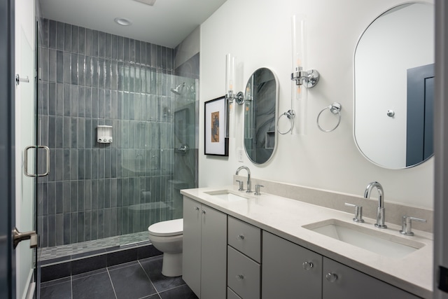 bathroom with tile patterned floors, vanity, toilet, and walk in shower