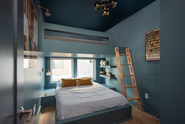 bedroom with dark hardwood / wood-style flooring and vaulted ceiling