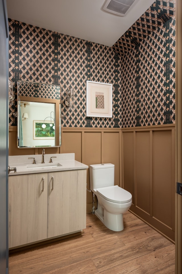 bathroom featuring vanity, toilet, and wood-type flooring