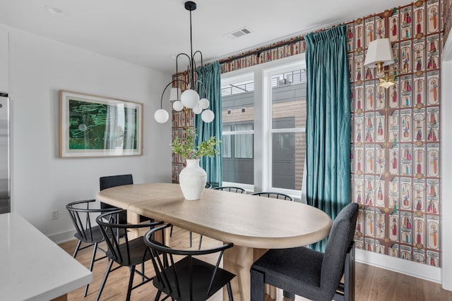 dining space featuring wood-type flooring