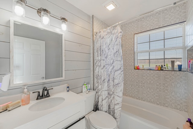 full bathroom with vanity, shower / bath combination with curtain, and toilet