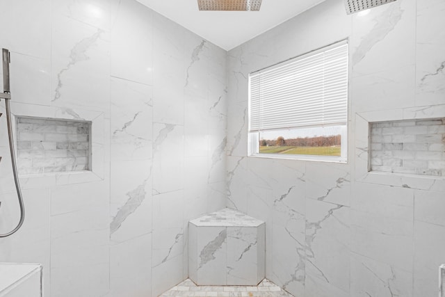 bathroom featuring a tile shower