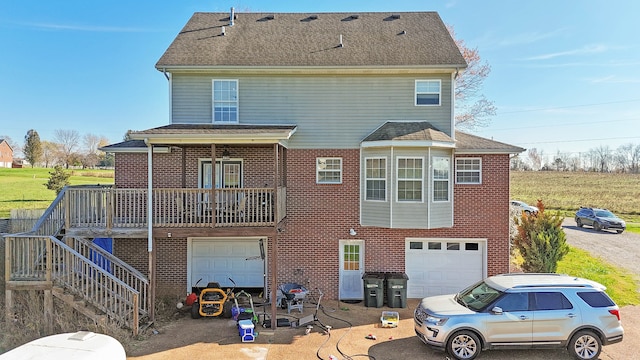 rear view of house with a garage