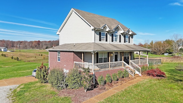 farmhouse inspired home with a porch and a front yard