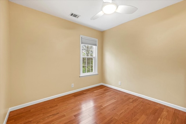 spare room with ceiling fan and wood-type flooring