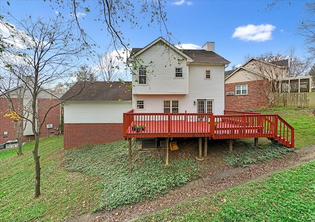 back of house with a deck and a yard