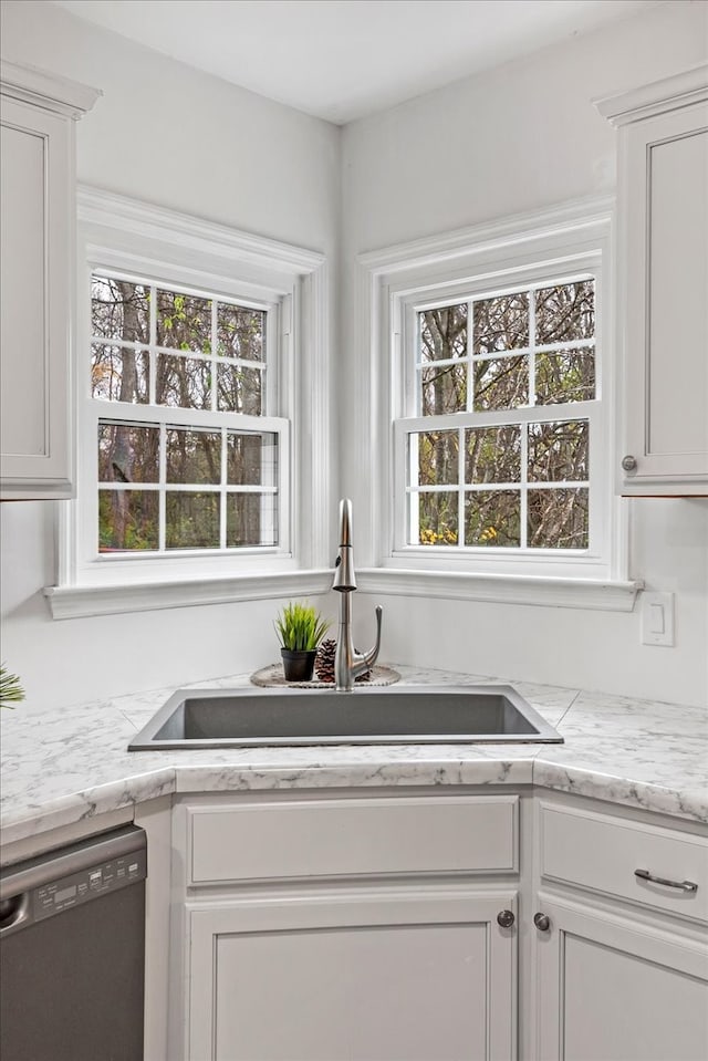 kitchen featuring dishwasher, a healthy amount of sunlight, white cabinetry, and sink