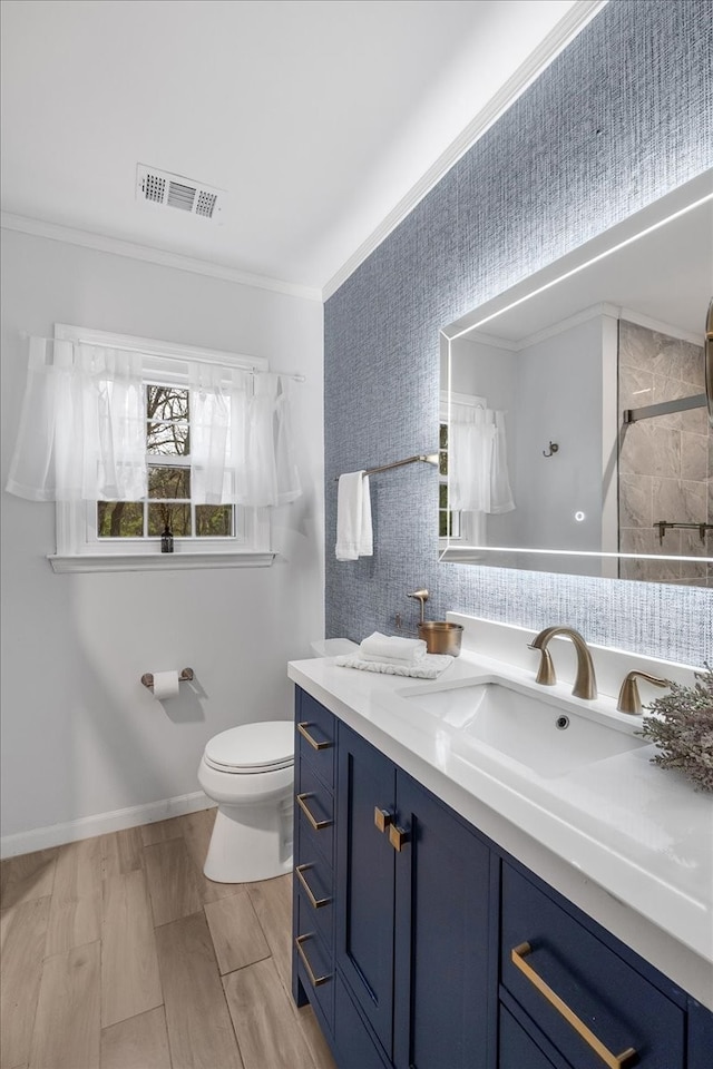 bathroom with vanity, crown molding, toilet, walk in shower, and wood-type flooring