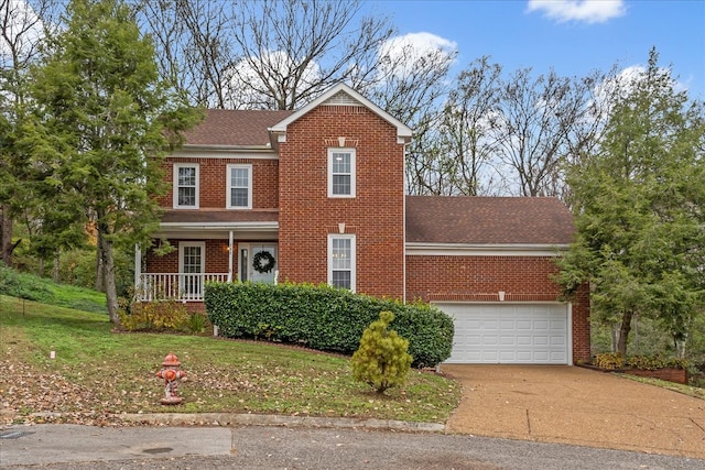 view of front of house featuring a porch, a garage, and a front lawn