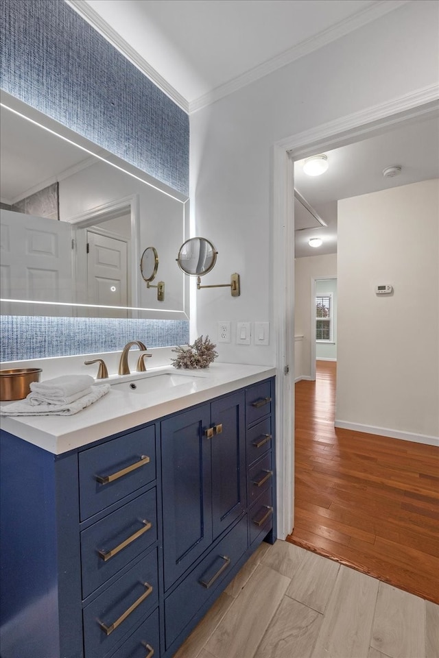 bathroom featuring crown molding, vanity, and hardwood / wood-style flooring