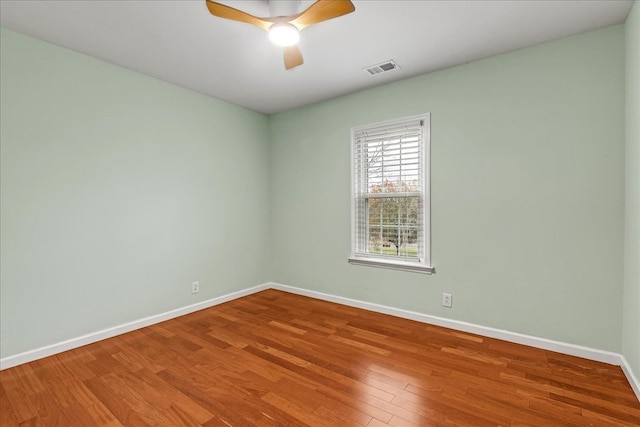 empty room with hardwood / wood-style flooring and ceiling fan