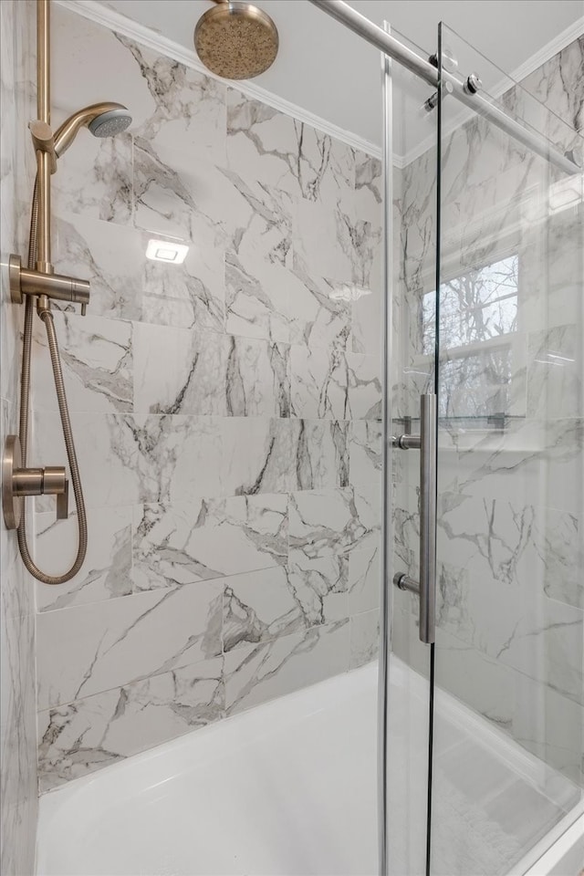 bathroom featuring ornamental molding and walk in shower