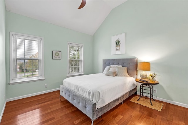 bedroom with wood-type flooring, ceiling fan, and lofted ceiling