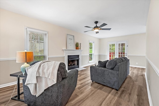 living room featuring ceiling fan, hardwood / wood-style floors, and french doors