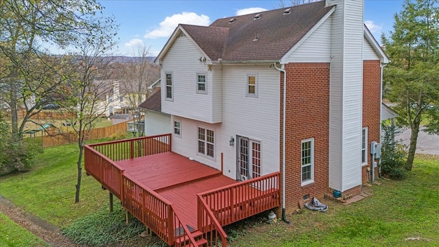 back of house with a yard and a deck