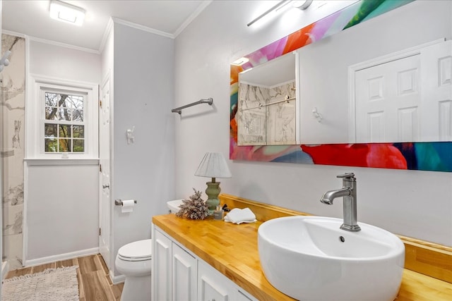 bathroom featuring walk in shower, vanity, crown molding, hardwood / wood-style floors, and toilet